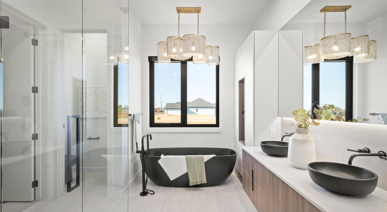 Luxury ensuite with black freestanding tub and woven chandelier