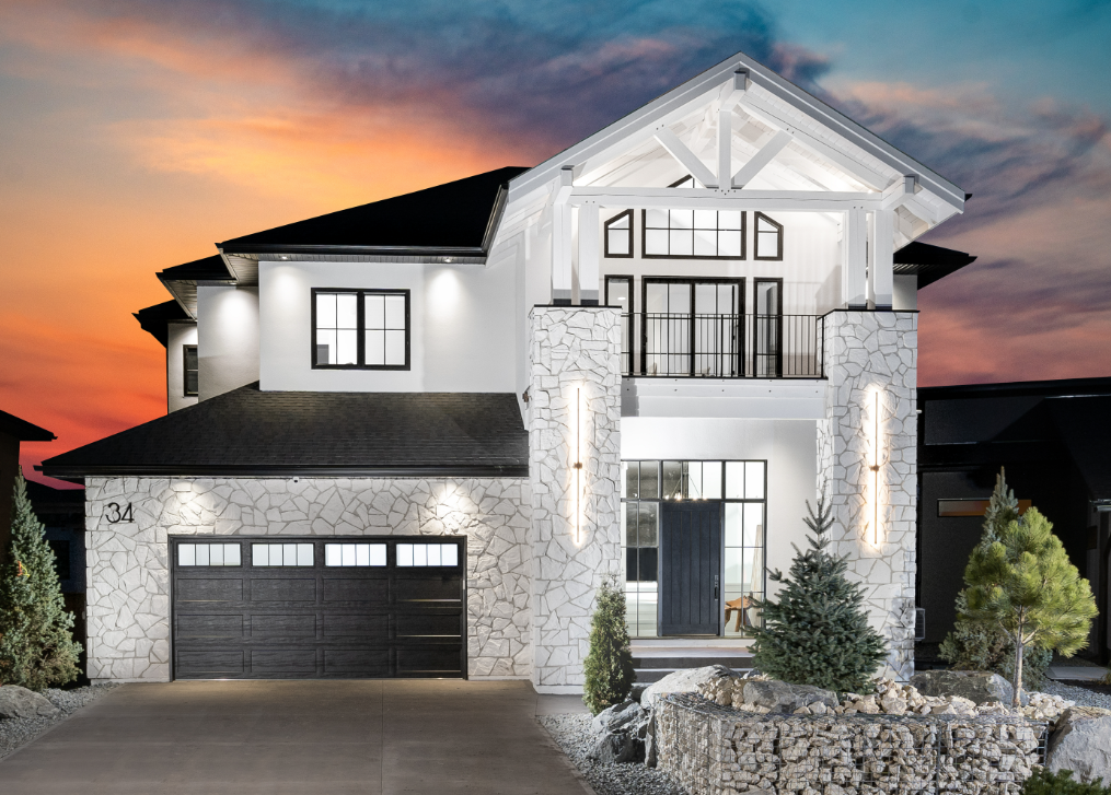 Modern two-storey home exterior with architectural lighting at sunset