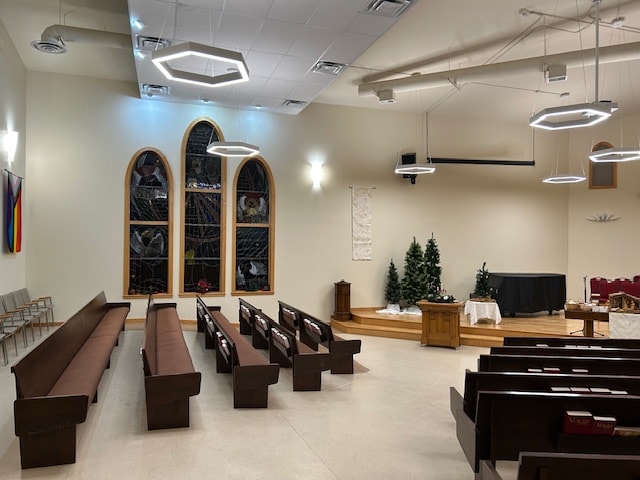 Church interior with hexagonal LED pendant fixtures and stained glass windows